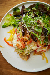 Grilled shrimp salad with tartar sauce and baguette 