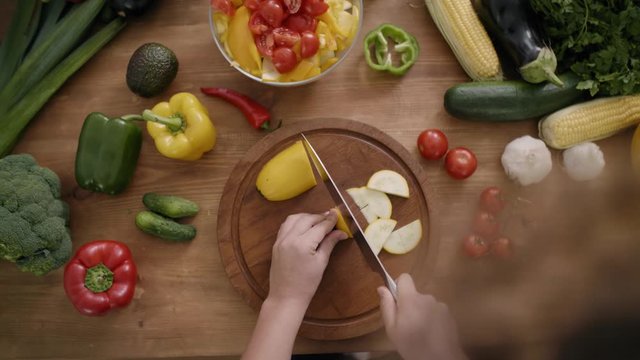 Handheld view of zucchini cut into slices