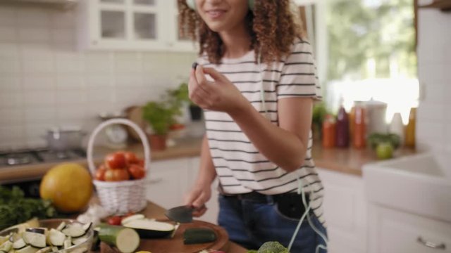 Young woman cooking in good mood