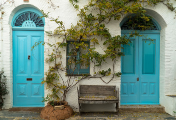 Cadaqués, Catalonia / Spain - November 30th, 2019: Two turquoise doors in the old town center