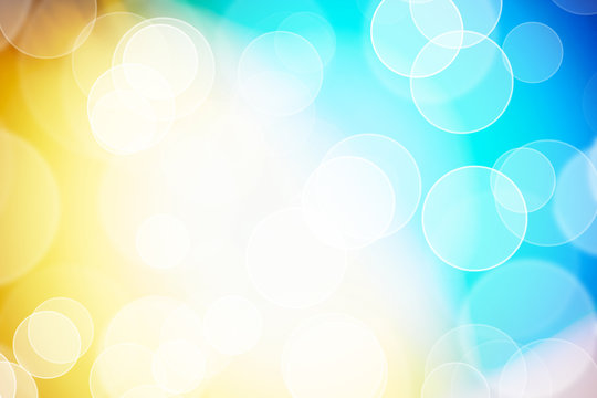 Defocused lights over gradient yellow, white, blue background