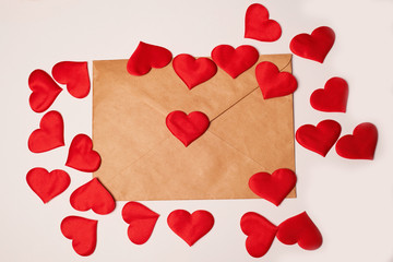 Kraft the envelope with red hearts on a white background. Congratulations on Valentine's Day.