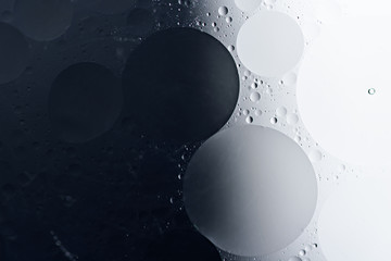 black and white abstract background of oil drops in shape of circle on water surface