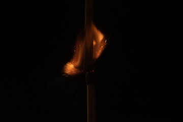 Ignition of match with sparks isolated on black background space for text fire concept passion...