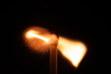 Ignition of match with sparks isolated on black background space for text fire concept passion...