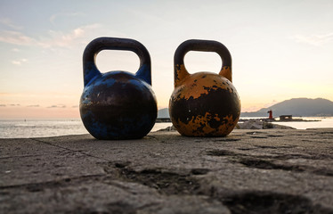 Obraz na płótnie Canvas Sunset With Two Kettlebells In The Harbour
