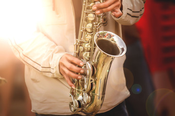 Obraz premium Musical instruments,Saxophone Player hands Saxophonist playing jazz music. Alto sax musical instrument closeup