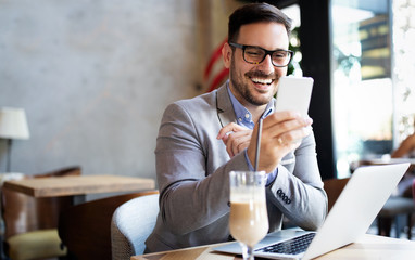 Portrait of businessman working, talking on mobile phone in office