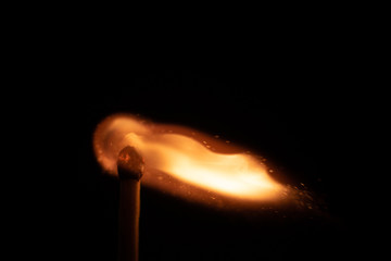 Ignition of match with sparks isolated on black background space for text fire concept passion...