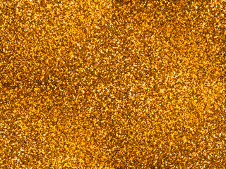 Golden glitter paper texture. Seamless background.