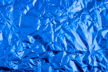 Abstract trendy blue colored crumpled foil texture background. 2020 year color trend concept.