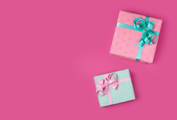 two gifts pink and mint on a pink background copy space