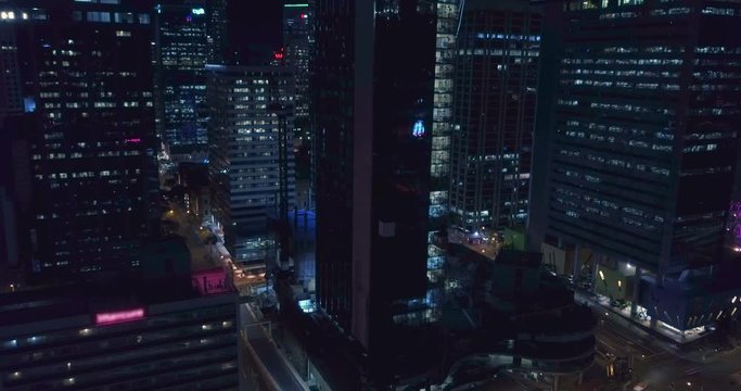 Rising, tilt down AERIAL timelapse hyperlapse of Brisbane city CBD traffic at night.