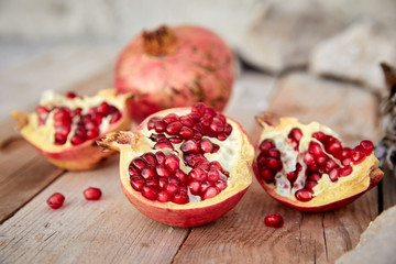 ripe organic pomegranate on teh wooden background
