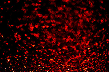 Abstract light, red bokeh pattern in heart shape on black. St Valentines Day or Holiday concept, background image.