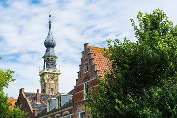 Fototapeta na wymiar stepped gable house and tower of town hall. Veere, The Netherlands