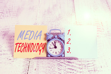 Conceptual hand writing showing Media Technology. Concept meaning process of huanalysis origin that used to convey media Mini blue clock standing above buffer wire between two paper