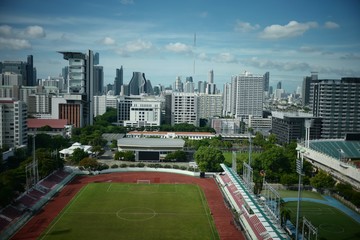 Naklejka premium Supachalasai Stadium, Bangkok, january 21, 2020 Aerial view of a football field on a stadium covered with green grass building in city