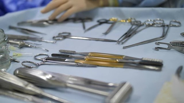 Concept medicine, surgery. Operating table with a tool for rhinoplasty, close-up, slow motion. The steril instruments are on the steril table.