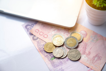 Many Thai Baht on the white desk