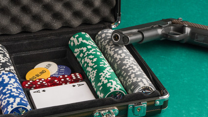 Poker set with a gun. The concept of gambling and entertainment. Casino and poker