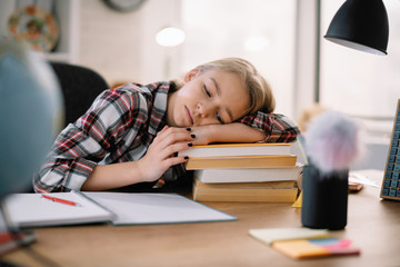 Cute little girl doesn't want to learn. Sad and tired schoolgirl. 