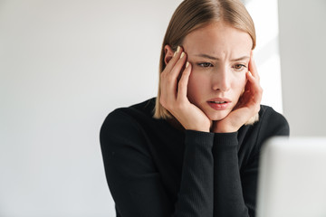 Business woman in office indoors work with laptop computer.