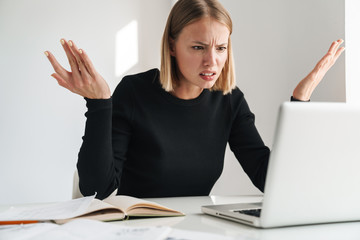 Blonde business woman work with documents and laptop
