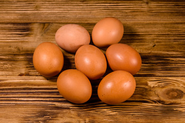 Pile of the hen eggs on wooden table