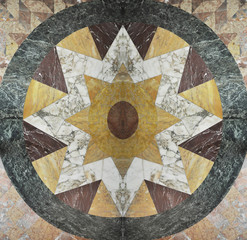 Colored marble flooring. Natural stone ornament. Star texture composed of elements of colored marble