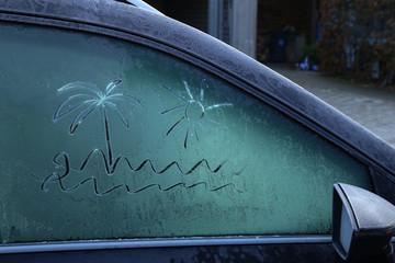 Drawing on frozen car windows on a frosty morning