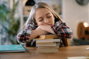 Cute little girl. Tired schoolgirl learning. 