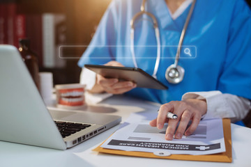 Medical Technology Concepts The doctor is working on a tablet and audio player and a digital tablet computer in a modern office  in the morning at the desk.