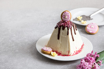 Easter food background. Traditional curd Easter cake with spring flowers crocus on the  light background. Easter cottage cheese dessert/