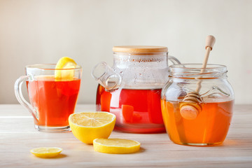 Tea with lemon and honey on table.