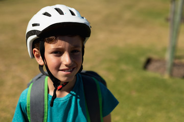 Fototapeta na wymiar Schoolboy wearing a cycling helmet and smiling to camera
