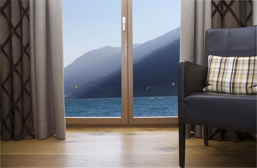 Window in a room overlooking the sea and mountains. Free space for your design. Background of summer landscape