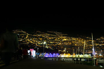 Fototapeta na wymiar Funchal in Madeira, Portugal, with many lights at night, view from the sea