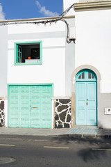 White house with light green doors and windows