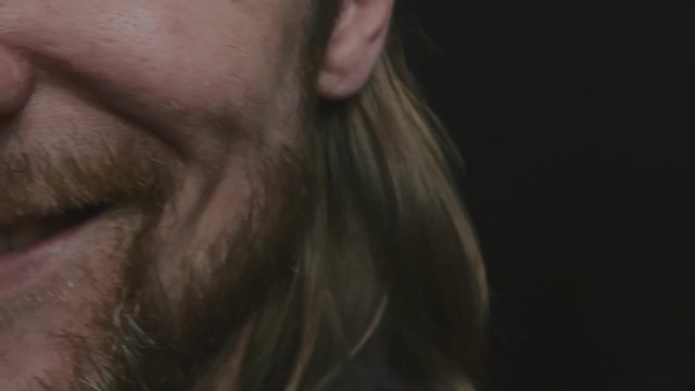 Detailed image of two bearded men smiling isolated