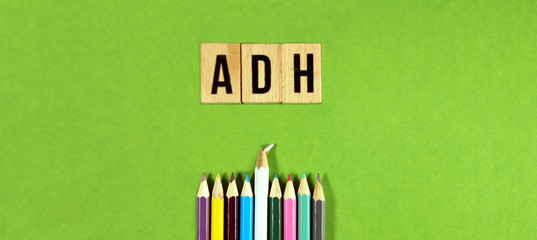 panoramic view of ADH - Antidiuretic Hormone acronym on wooden blocks with multicolored pencils on...