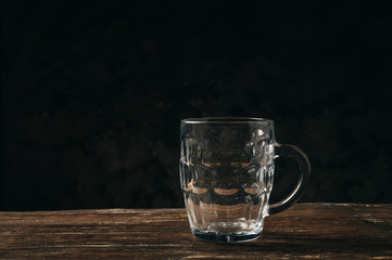 Empty beer glass mug on a wooden table.