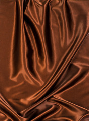 Abstract brown wavy textile silk background with chocolate, cocoa, coffee color