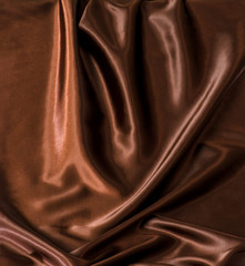 Abstract brown wavy textile silk background with chocolate, cocoa, coffee color