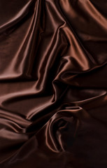 Abstract brown wavy textile silk background with chocolate, cocoa, coffee color