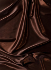 Abstract brown wavy textile silk background with chocolate, cocoa, coffee color