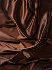 Abstract brown wavy textile silk background with chocolate, cocoa, coffee color