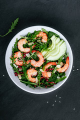 Shrimp salad with fresh green arugula leaves and avocado, radicchio, almond and sesame seeds.