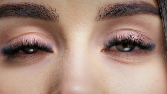 close-up of a young girl's eyes. The girl blinks and looks tenderly
