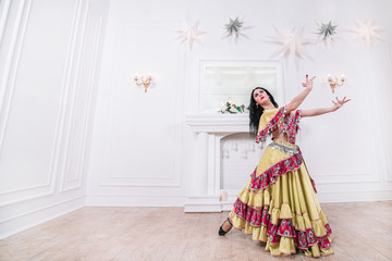 Fototapeta premium Gypsy woman performing a passionate dance. photo with space for text